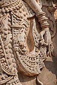 Chiang Mai - The Wat Phra Singh temple. The ho trai (temple library). The stucco figures in high relief of the base showing dancing Devas. 